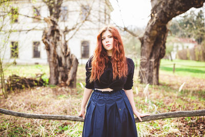 Beautiful redhead young woman outdoor portrait. spring season, country side