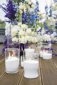 Close-up of lit tea light candles on table