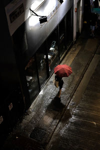 Man walking on wet road during rainy season