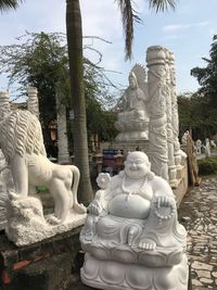 Statue of buddha against trees