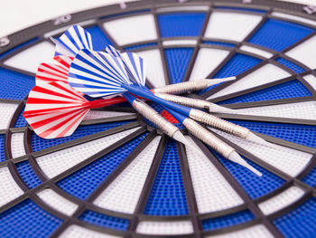 Close-up of darts on dartboard