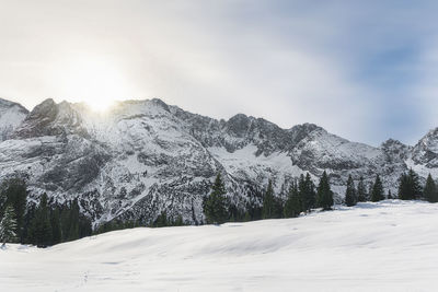 Scenic view of snow covered mountains against sky