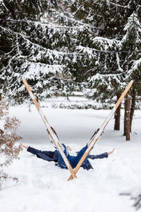 Beautiful cold forest view and skier wearing in skis that lying and relaxing after skiing. winter 