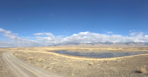 Scenic view of desert against blue sky