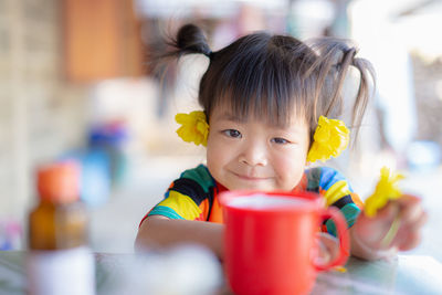 Portrait of cute boy drinking coffee