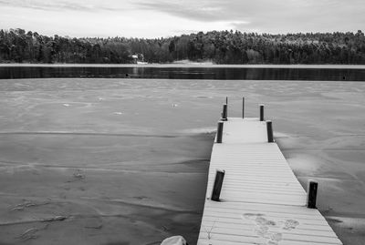 Scenic view of lake against sky during winter