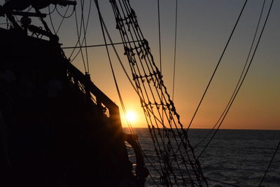 Silhouette of sailboat against sky during sunset