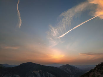 Low angle view of silhouette mountains against sky during sunset