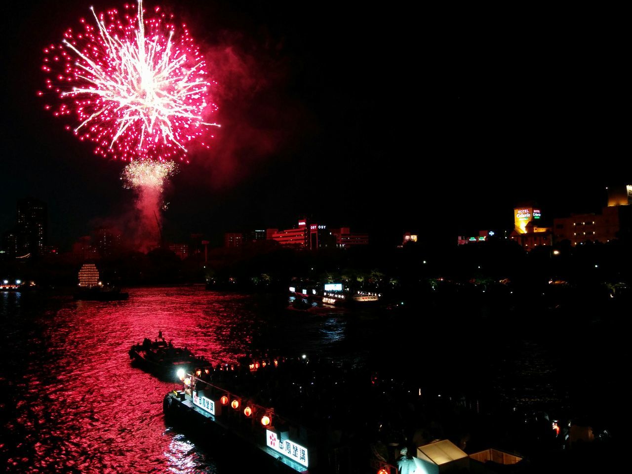 illuminated, night, building exterior, architecture, built structure, glowing, city, reflection, water, celebration, river, sky, long exposure, firework display, lighting equipment, multi colored, arts culture and entertainment, exploding, waterfront, outdoors