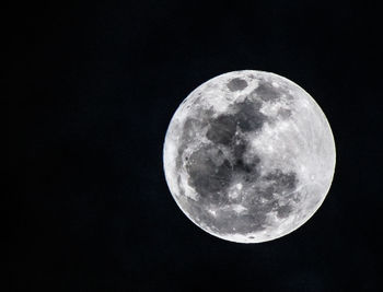 Low angle view of moon against black sky