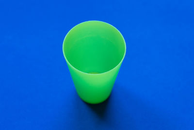 Close-up of green glass on blue background