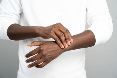 Close-up of woman hand against white background