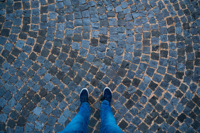 Low section of person standing on footpath