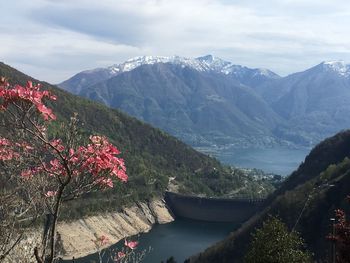 Scenic view of lake by mountains against sky