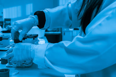 Cropped hand of scientist working in laboratory