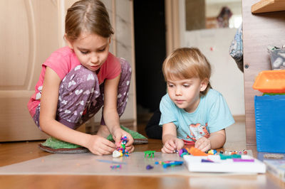 Children playing with toy on table