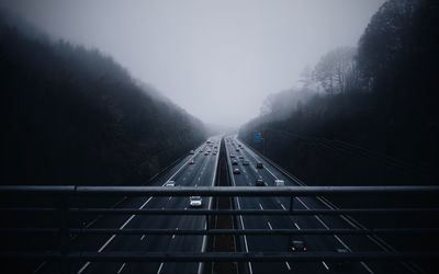 Road amidst trees against sky