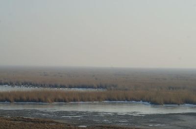 Scenic view of snow covered landscape against clear sky