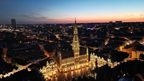 High angle view of illuminated cityscape against sky during sunset at brussels.