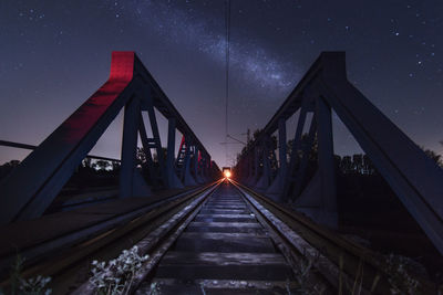 View of suspension bridge against sky at night