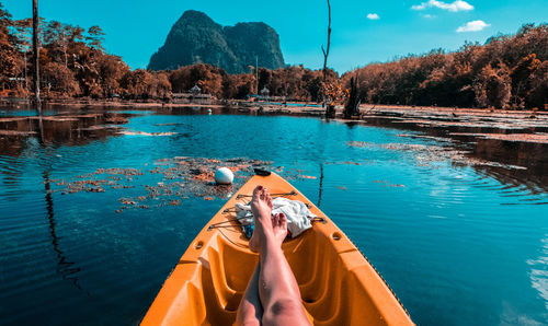 Low section of man relaxing in swimming pool