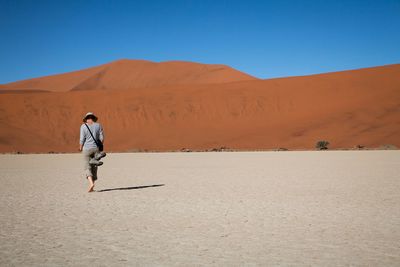 Woman standing on arid landscape