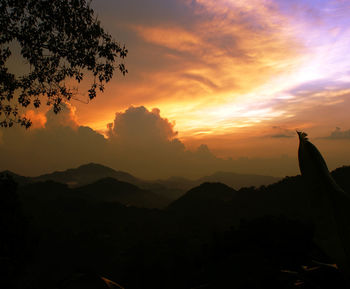 Scenic view of mountains against sky at sunset