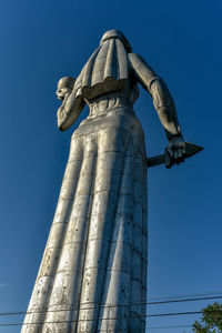 Low angle view of statue against clear blue sky