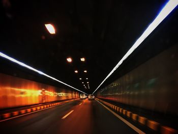 Illuminated tunnel at night