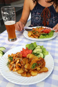 Close-up of woman having food on table