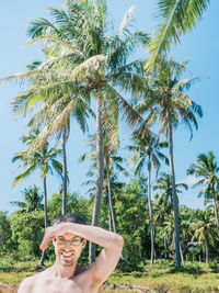 Portrait of man with palm trees