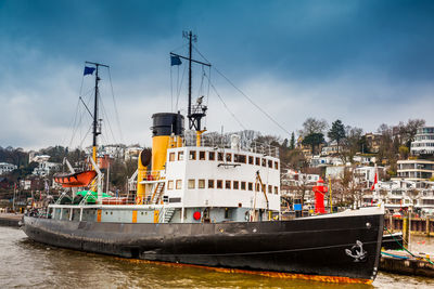 Ship and buildings on the banks of the elbe river in hamburg in a cold end of winter day