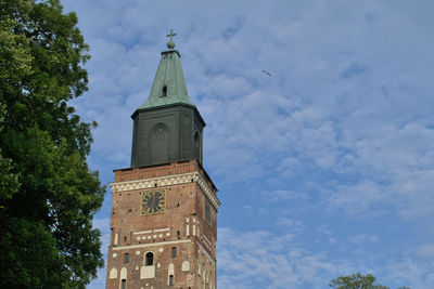 Low angle view of clock tower against sky