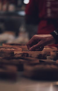 Cropped hand of chef preparing food in kitchen