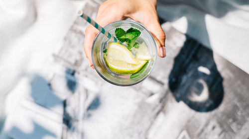 Cropped hand holding mojito glass