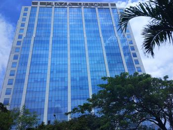 Low angle view of office building against blue sky