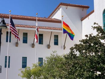 Low angle view of flags hanging against building