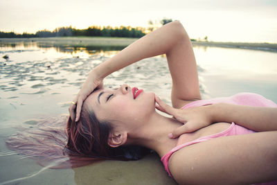 Midsection of woman lying in water