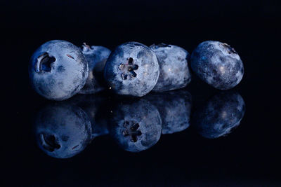 Close-up of blueberries against black background