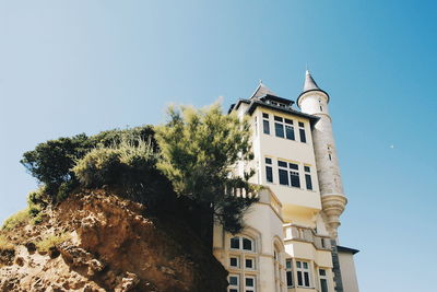 Low angle view of building against blue sky