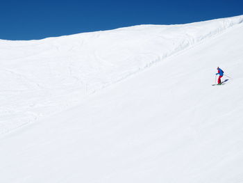 Distant view of person skiing in snow