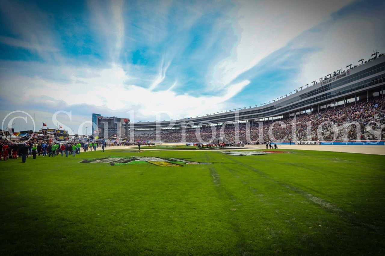 grass, cloud - sky, architecture, sky, crowd, group of people, built structure, large group of people, building exterior, day, nature, real people, green color, plant, sport, travel destinations, travel, outdoors, stadium, spectator