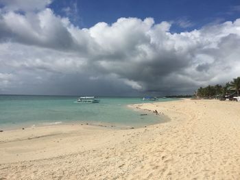 View of beach against cloudy sky