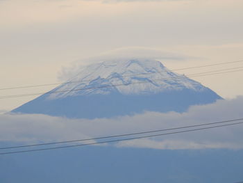 Low angle view of snowcapped mountain against sky