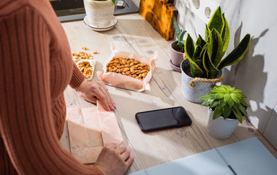 High angle view of woman preparing food on table