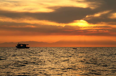 Scenic view of sea against orange sky
