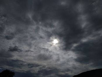 Low angle view of silhouette moon against sky at night