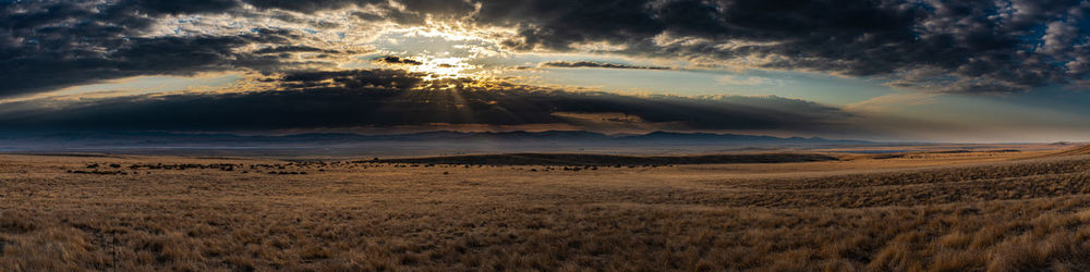 Scenic view of land against sky during sunset