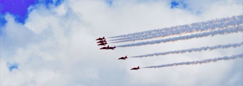 Low angle view of airshow against sky