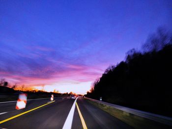 Highway against sky at sunset